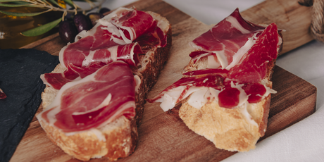 Whole leg of Spanish jamón ibérico de bellota on a stand, ready for slicing