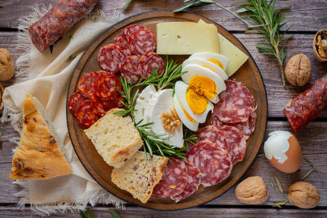 Spanish cured chorizo sliced next to crumbled fresh Mexican chorizo in a pan
