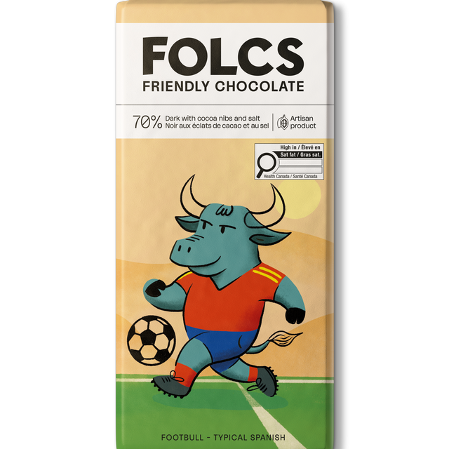A bar of FOLCS Friendly Chocolate featuring a colorful illustration of a bull soccer player on a field. The packaging is cream and beige with a white top section containing the brand name 'FOLCS' and product details.