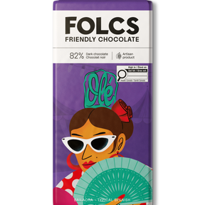 A bar of FOLCS Friendly Chocolate, 82% dark chocolate, featuring a purple wrapper with a colorful illustration of a woman in sunglasses holding a fan.
